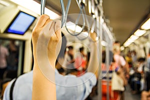 Woman holding onto a handle