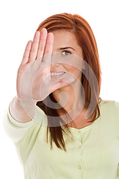 Woman holding out her hand in a stop signal photo