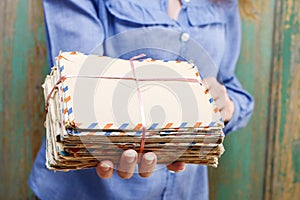 Woman holding package of vintage letters