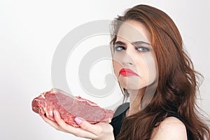 Woman holding packaged meat at the supermarket