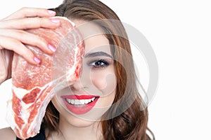 Woman holding packaged meat at the supermarket