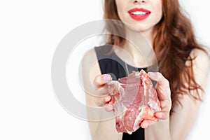 Woman holding packaged meat at the supermarket