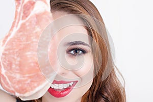 Woman holding packaged meat at the supermarket