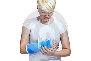 Woman holding painful broken arm photo