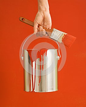 Woman holding paint can.