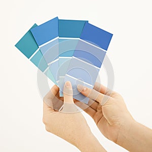 Woman holding paint swatches. photo