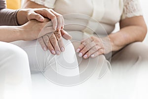 Woman holding palm of pensioner