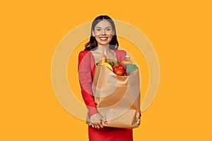 Woman Holding Paper Bag Full of Groceries