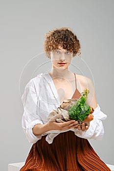 Woman holding paper bag with vegetables