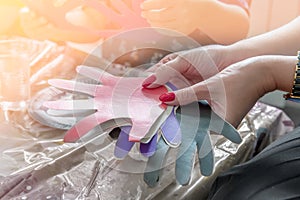 A woman holding a paper-cut small children`s symbols. The teacher is engaged with children. Training. Toned