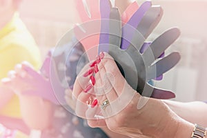 A woman holding a paper-cut small children`s symbols. The teacher is engaged with children. Training. Toned