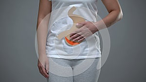 Woman holding paper stomach sign, gastritis prevention, gastrointestinal tract