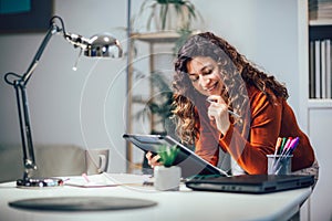 Woman holding papers in her hands, calculating family budget