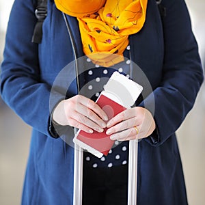 Woman holding passport and boarding pass