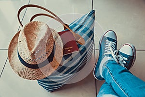 Woman holding passport with boarding pass close up at airport