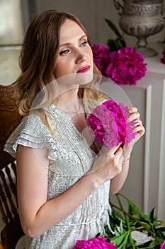 Woman holding peony bud in her hands