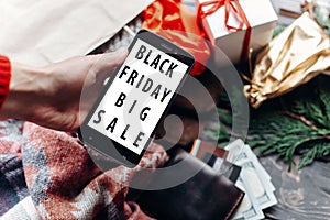 Woman holding phone with black friday big sale special offer dis
