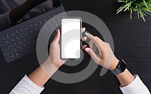 Woman holding phone showing white screen on top view