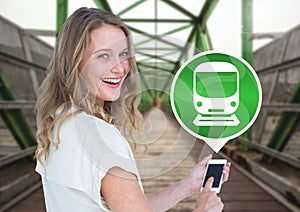 Woman holding phone with train icon on railway track