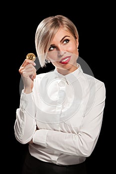 Woman holding physical bitcoin cryptocurrency coins in her hands
