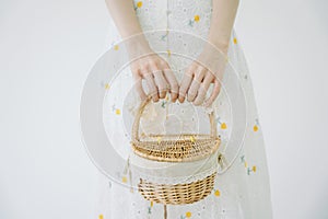 Woman holding picnic basket isolate over white background