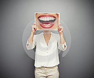 Woman holding picture with big smile