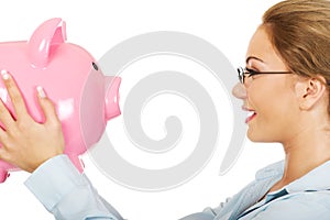 Woman holding piggy bank.