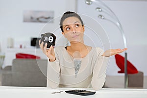 woman holding piggy bank other hand empty