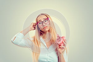 Woman holding piggy thinking cute