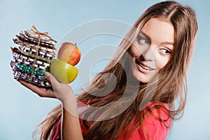 Woman holding pills and fruits. Health care