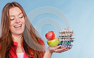 Woman holding pills and fruits. Health care