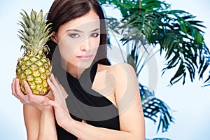 Woman holding pineapple