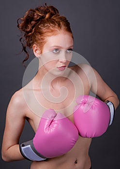 Woman Holding Pink Boxing Gloves in Front of Chest