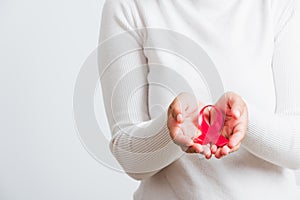 Woman holding pink breast cancer awareness ribbon on hands