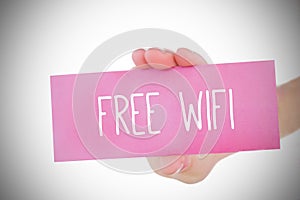 Woman holding pink card saying free wifi