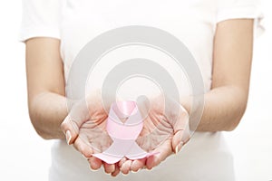 Woman holding a pink ribbon.