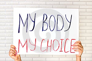 Woman holding a placard with My Body My Choice text. Reproductive women and pro-abortion rights protest concept.