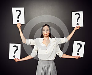 Woman holding placards with question mark