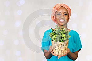 Woman holding plant in vase