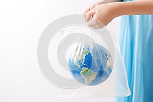 Woman holding plastic bag with globe and space