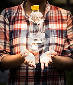 Woman holding a plastic bottle