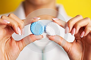 Woman holding plastic container with contact lenses