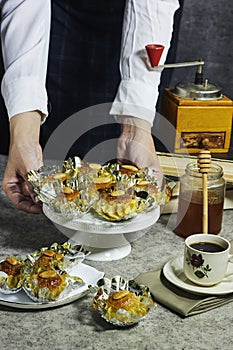 woman holding a plate of Oriental Algerian sweet cookies named dziriettes