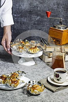 woman holding a plate of Oriental Algerian sweet cookies named dziriettes