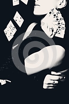 Woman holding playing cards, retro style photo.