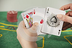 Woman holding poker aces with chips