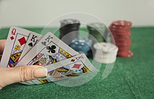 Woman holding poker aces with chips