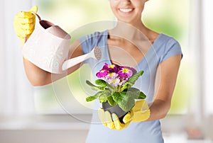 Woman holding pot with flower