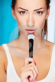 Woman holding powder brush