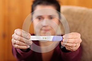 Woman holding a pregnancy test